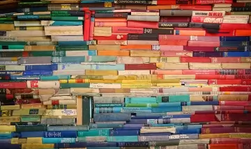 a colorful bookshelf arranged in a rainbow